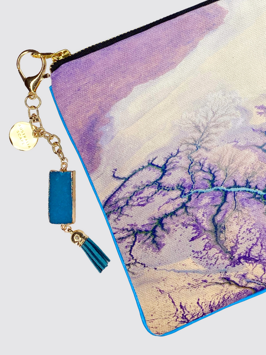 The Alligator Rivers clutch bag comes with a steel zipper and blue geode charm.