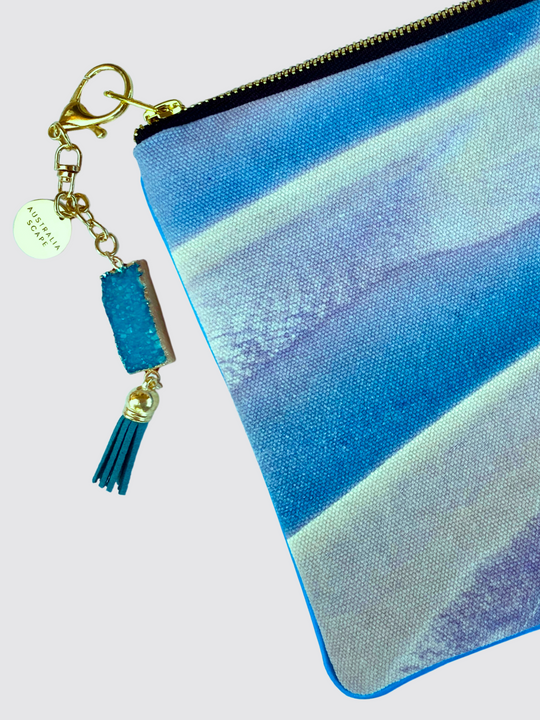 The Broome (sandbank) clutch bag comes with a steel zipper and blue geode charm.