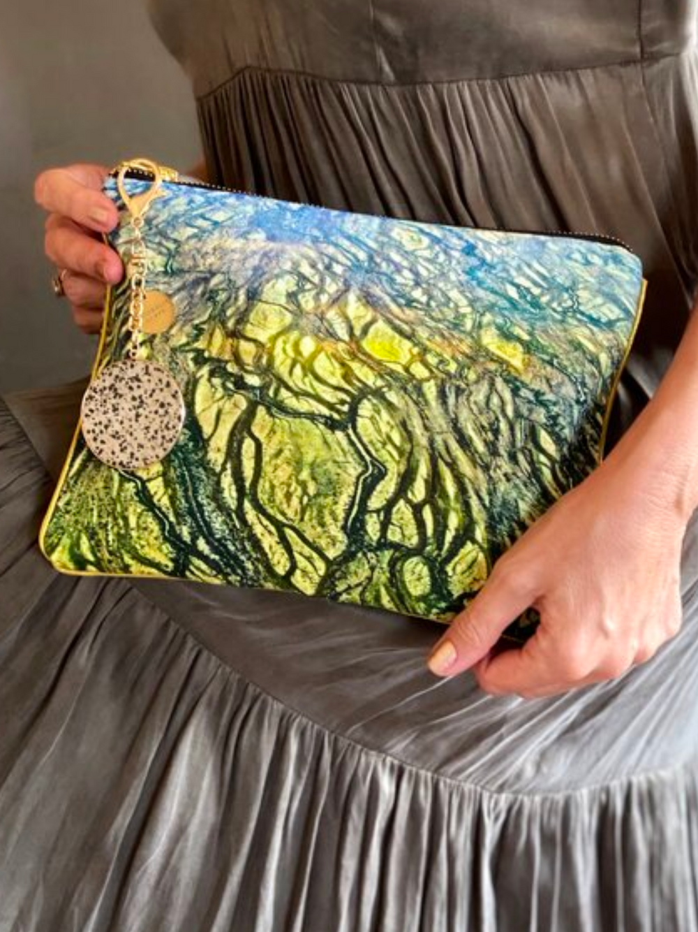 Our model accessorising an Australian landscape with the Diamantina River clutch bag.