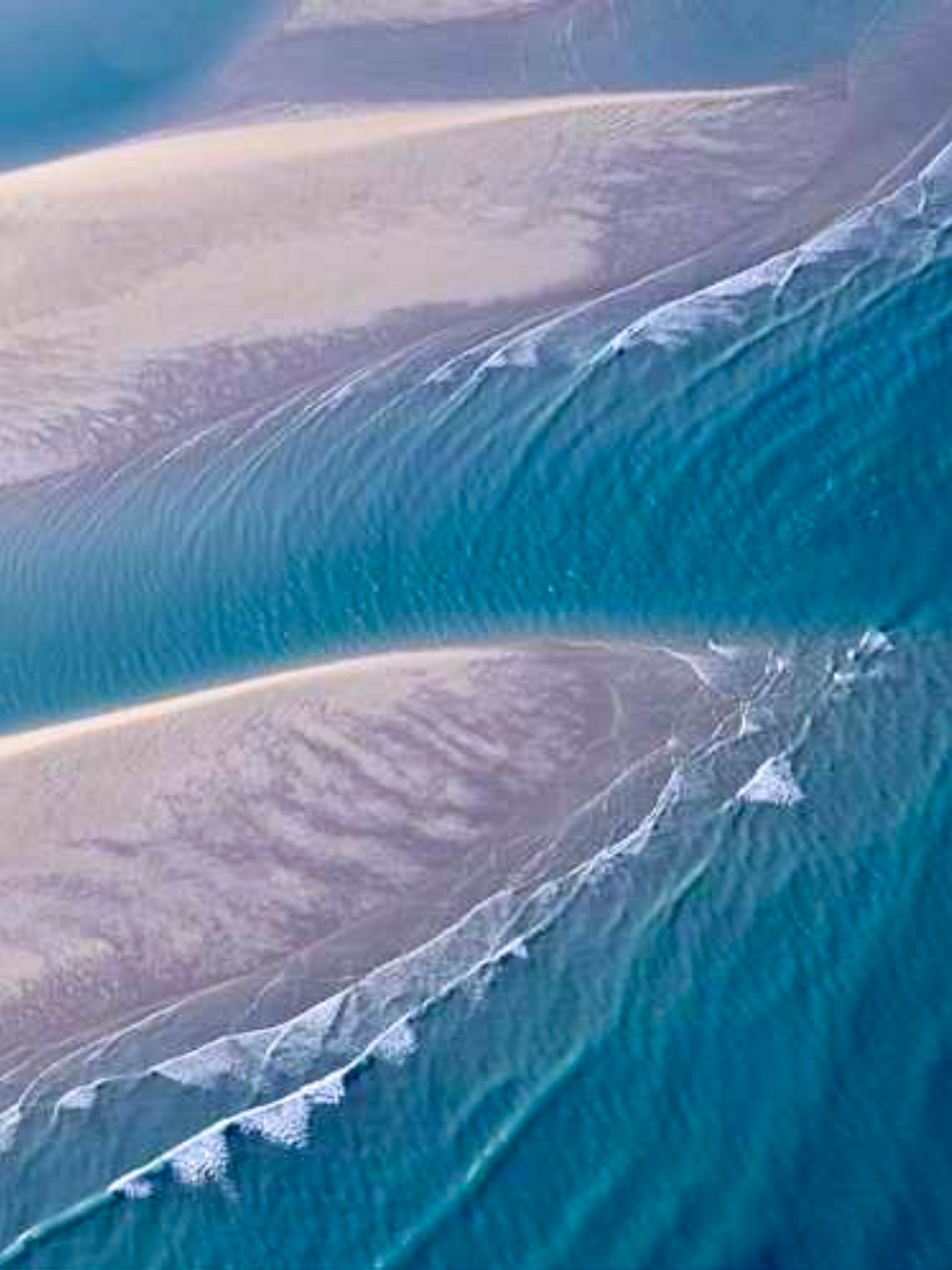 A magical aerial image of a Broome land/seascape in Western Australia – showing the aqua Indian ocean sculpting beautiful shapes in the coastal shallows.