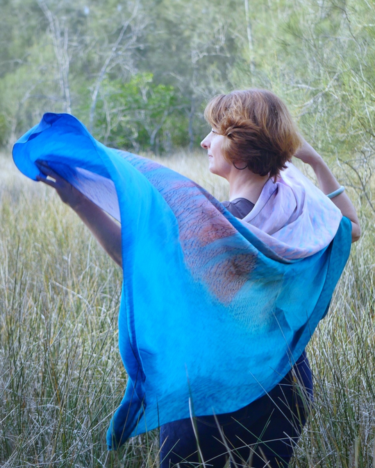 Our model accessorising an Australian landscape with the Broome (shoal) silk scarf.