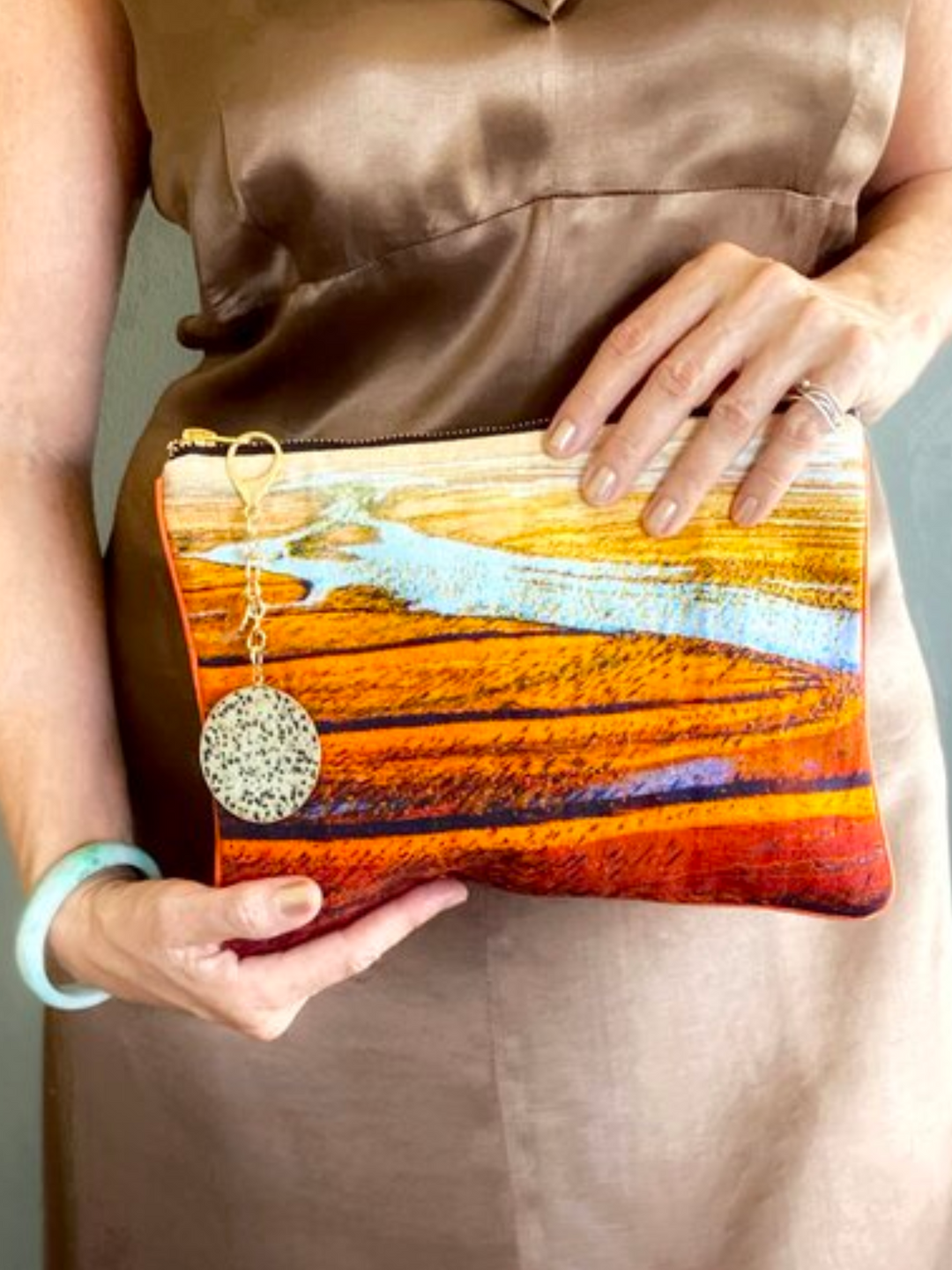 Australia Scape designer cotton canvas clutch bag depicting the Simpson Desert landscape in red, orange and blue tones.