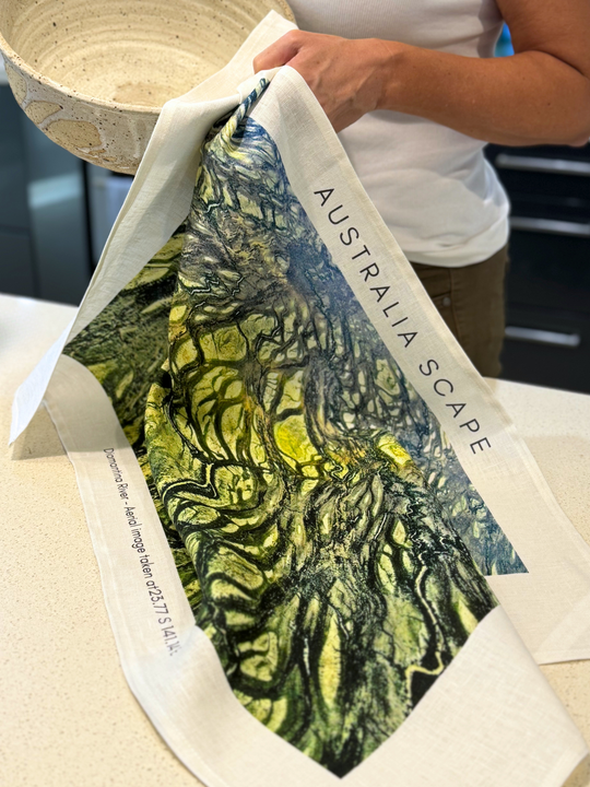Australia Scape designer tea towel in 100% linen depicting the Diamantina River channels in green and gold tones.