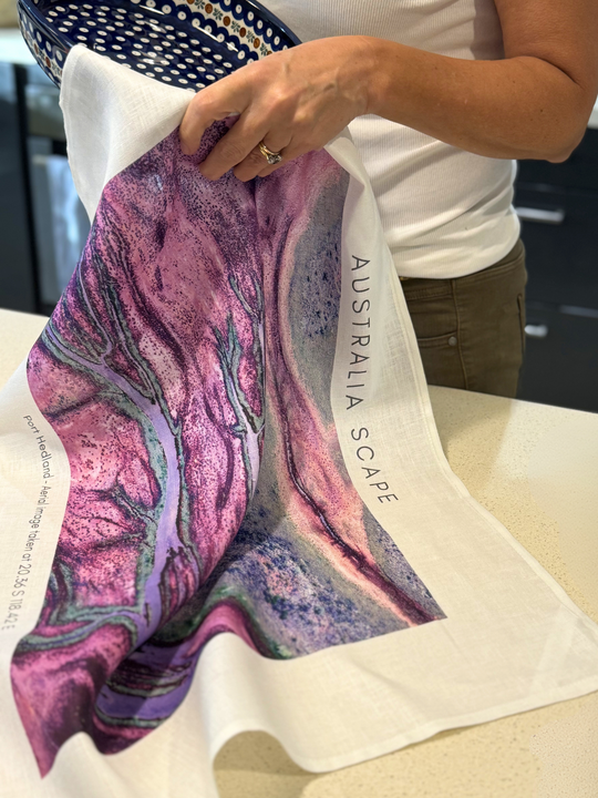 Australia Scape designer tea towel in 100% linen depicting the Port Hedland estuary in vibrant pink and blue tones.