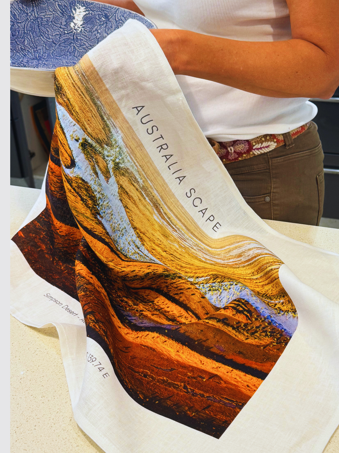 Australia Scape designer tea towel in 100% linen depicting the Simpson Desert in red, orange and blue tones.